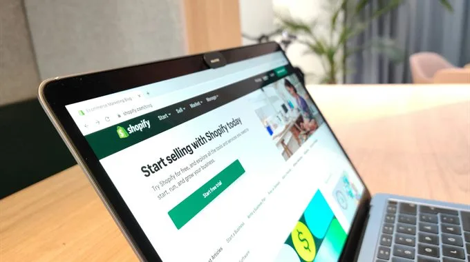 The Shopify sign-up page open on a laptop