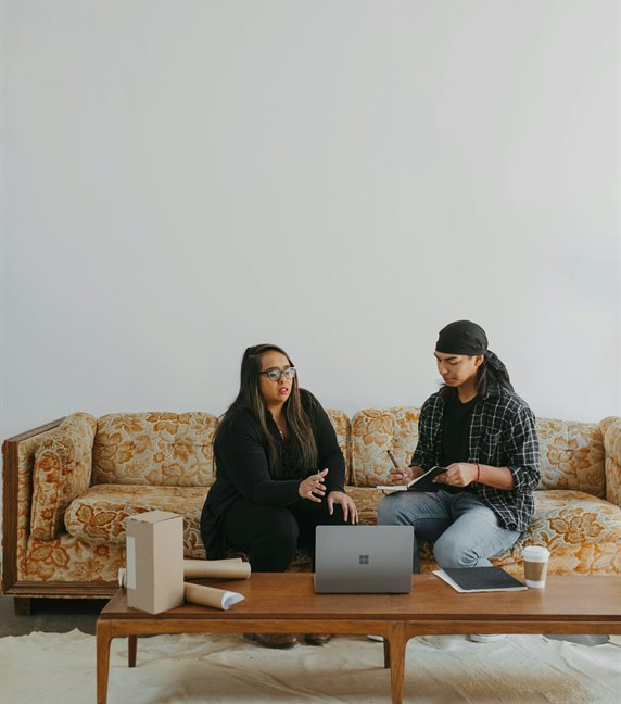 Two people working together on laptops